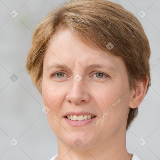 Joyful white adult female with short  brown hair and grey eyes