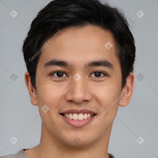 Joyful asian young-adult male with short  brown hair and brown eyes