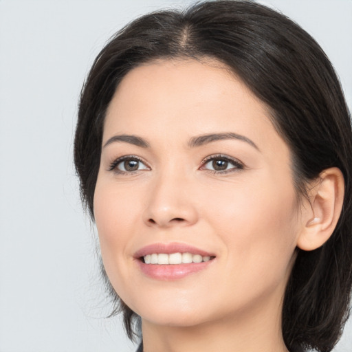 Joyful white young-adult female with medium  brown hair and brown eyes