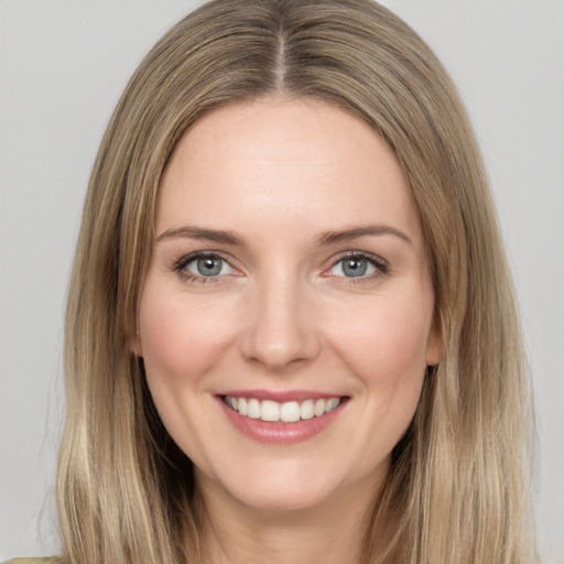 Joyful white young-adult female with long  brown hair and grey eyes