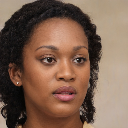 Neutral black young-adult female with long  brown hair and brown eyes