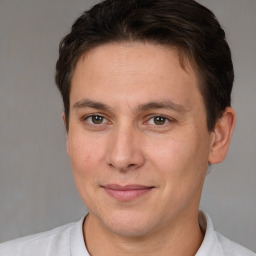 Joyful white adult male with short  brown hair and brown eyes