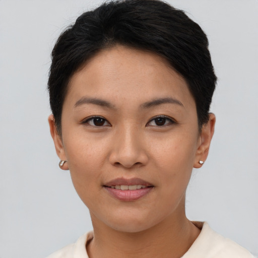 Joyful asian young-adult female with short  brown hair and brown eyes