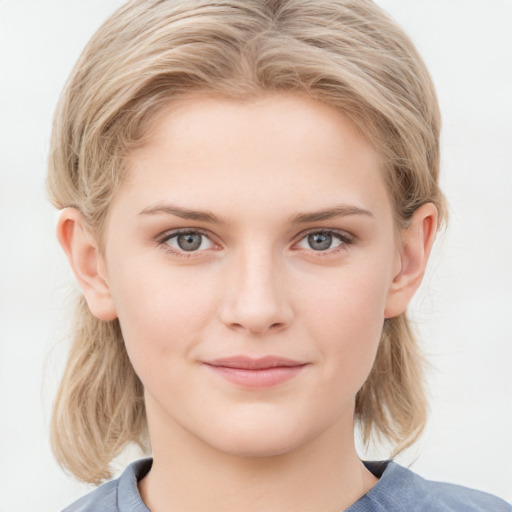 Joyful white young-adult female with medium  brown hair and blue eyes