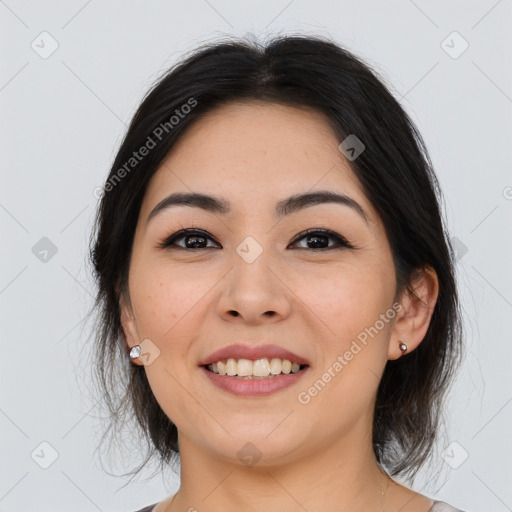 Joyful asian young-adult female with medium  black hair and brown eyes