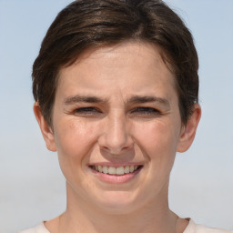 Joyful white adult female with short  brown hair and brown eyes