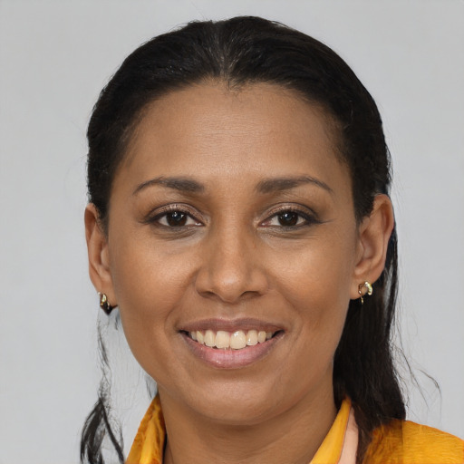 Joyful black young-adult female with medium  brown hair and brown eyes