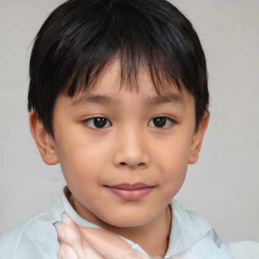 Joyful white child male with short  brown hair and brown eyes