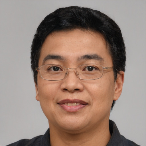 Joyful latino adult male with short  black hair and brown eyes