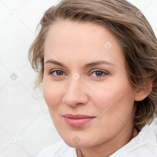 Joyful white young-adult female with medium  brown hair and blue eyes