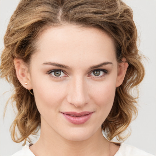 Joyful white young-adult female with medium  brown hair and green eyes