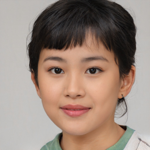 Joyful asian child female with medium  brown hair and brown eyes