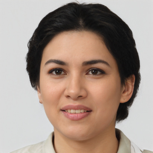 Joyful latino young-adult female with medium  black hair and brown eyes