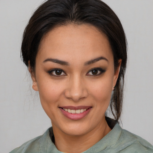 Joyful asian young-adult female with medium  brown hair and brown eyes