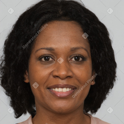 Joyful black adult female with medium  brown hair and brown eyes