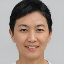 Joyful asian young-adult female with short  black hair and brown eyes