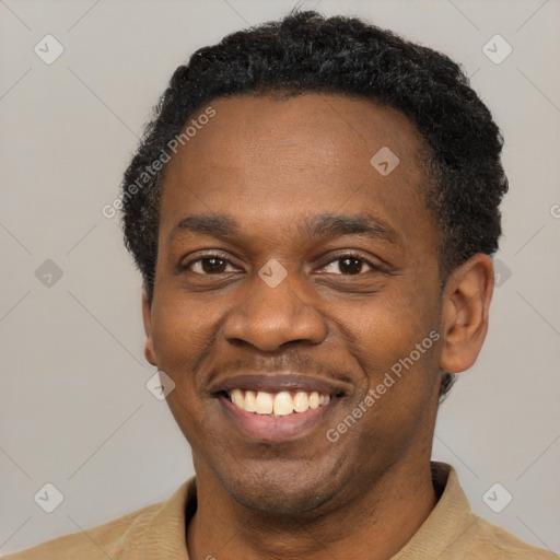 Joyful black young-adult male with short  black hair and brown eyes