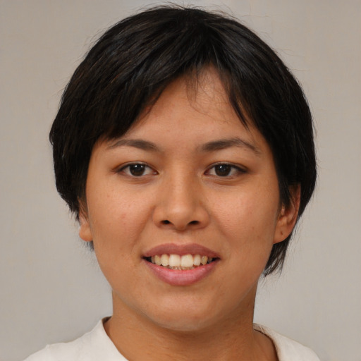 Joyful asian young-adult female with medium  brown hair and brown eyes