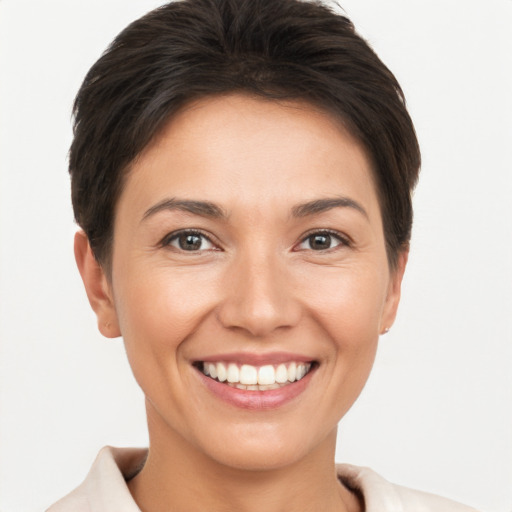 Joyful white young-adult female with short  brown hair and brown eyes