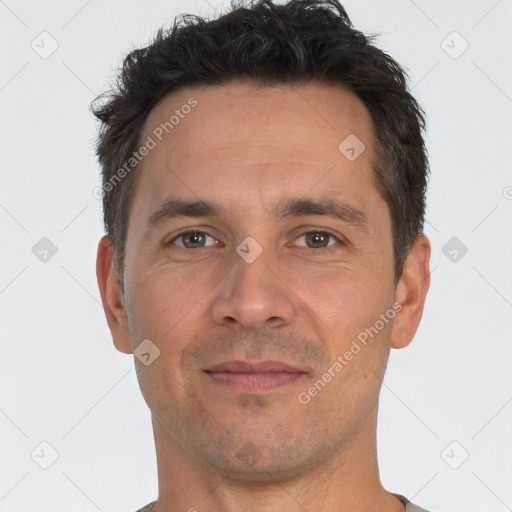 Joyful white adult male with short  brown hair and brown eyes