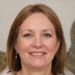 Joyful white adult female with medium  brown hair and grey eyes