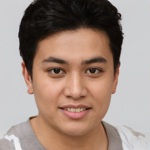Joyful asian young-adult male with short  brown hair and brown eyes