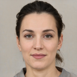 Joyful white adult female with medium  brown hair and brown eyes