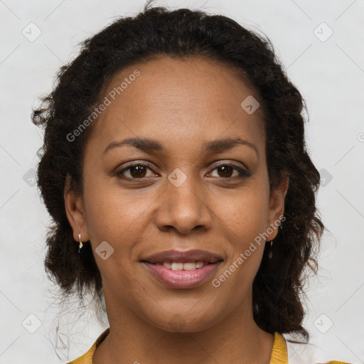 Joyful black adult female with short  brown hair and brown eyes