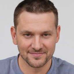 Joyful white adult male with short  brown hair and brown eyes