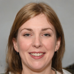 Joyful white adult female with medium  brown hair and grey eyes