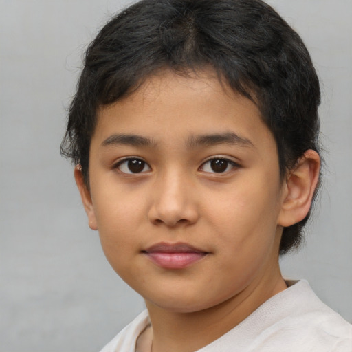 Joyful asian child female with short  brown hair and brown eyes