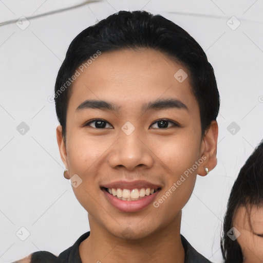 Joyful asian young-adult male with short  black hair and brown eyes