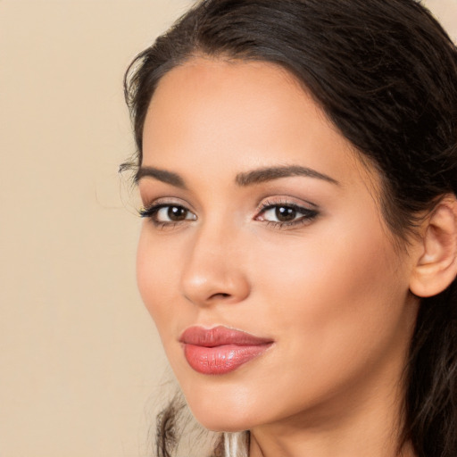 Joyful latino young-adult female with long  brown hair and brown eyes