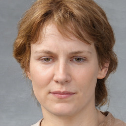 Joyful white adult female with medium  brown hair and blue eyes