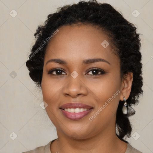 Joyful black young-adult female with long  brown hair and brown eyes