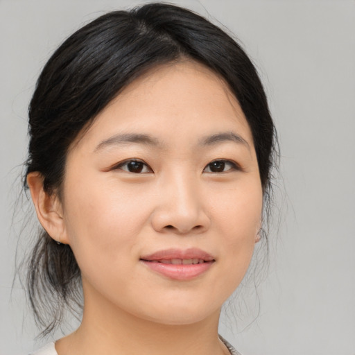 Joyful asian young-adult female with medium  black hair and brown eyes