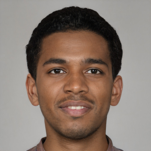 Joyful black young-adult male with short  brown hair and brown eyes