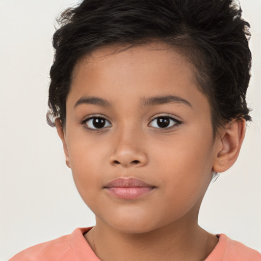 Joyful latino child female with short  brown hair and brown eyes