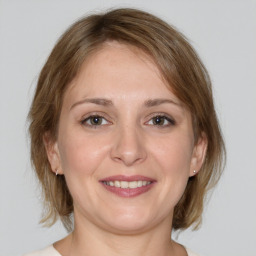 Joyful white adult female with medium  brown hair and grey eyes