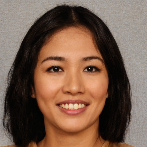 Joyful asian young-adult female with medium  brown hair and brown eyes