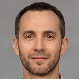 Joyful white adult male with short  brown hair and brown eyes