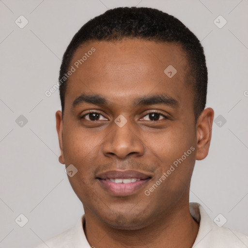 Joyful black young-adult male with short  black hair and brown eyes