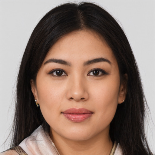 Joyful asian young-adult female with long  brown hair and brown eyes