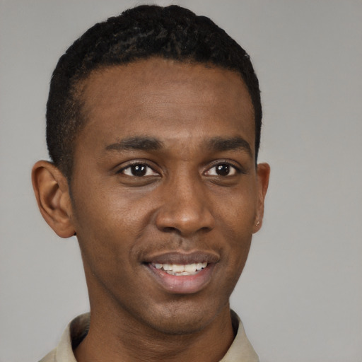Joyful black young-adult male with short  black hair and brown eyes
