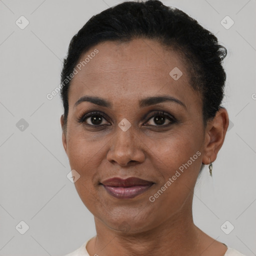 Joyful black adult female with short  brown hair and brown eyes