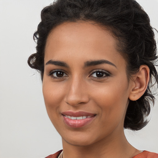 Joyful latino young-adult female with long  brown hair and brown eyes