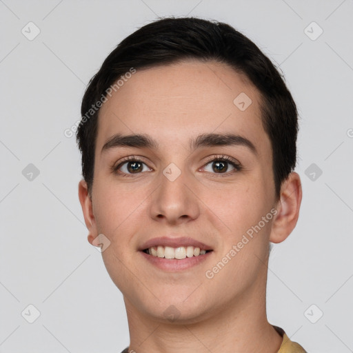 Joyful white young-adult male with short  black hair and brown eyes