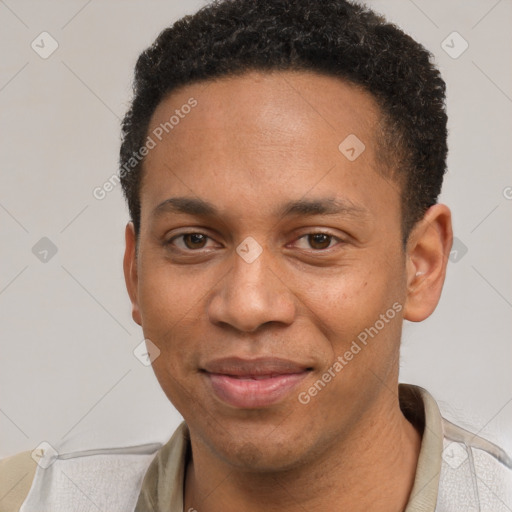 Joyful black young-adult male with short  brown hair and brown eyes