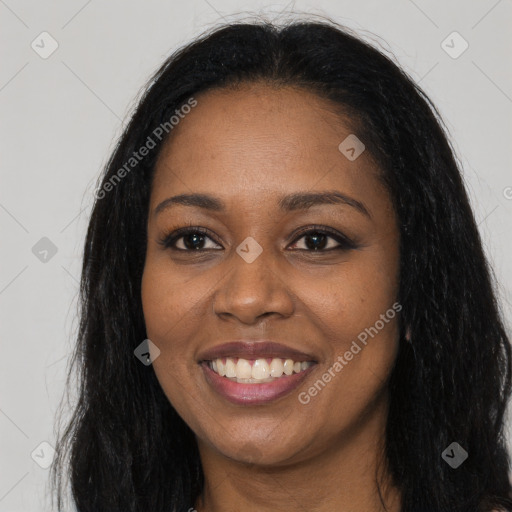 Joyful black young-adult female with long  brown hair and brown eyes