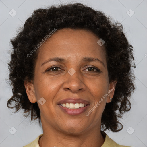 Joyful black adult female with short  brown hair and brown eyes